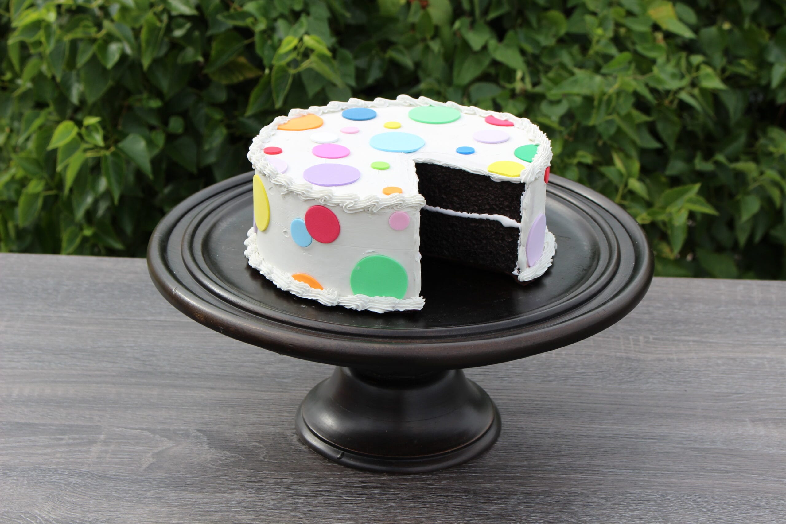 Fake Large Vanilla Frosted Cake with Polka Dots and  Slice Removed